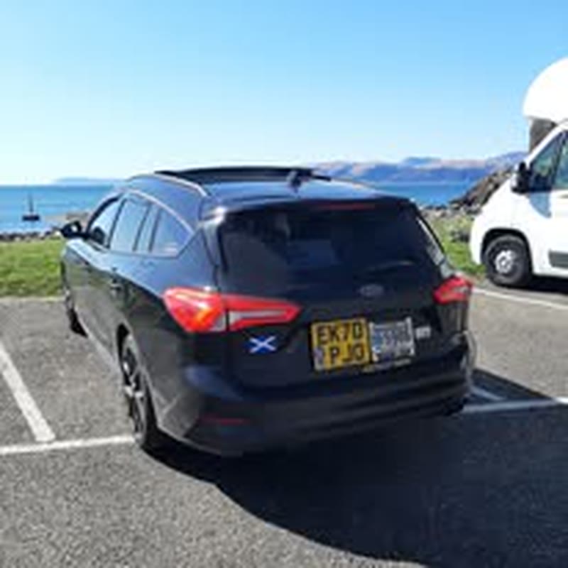 Ford Focus estate taxi parked by the sea